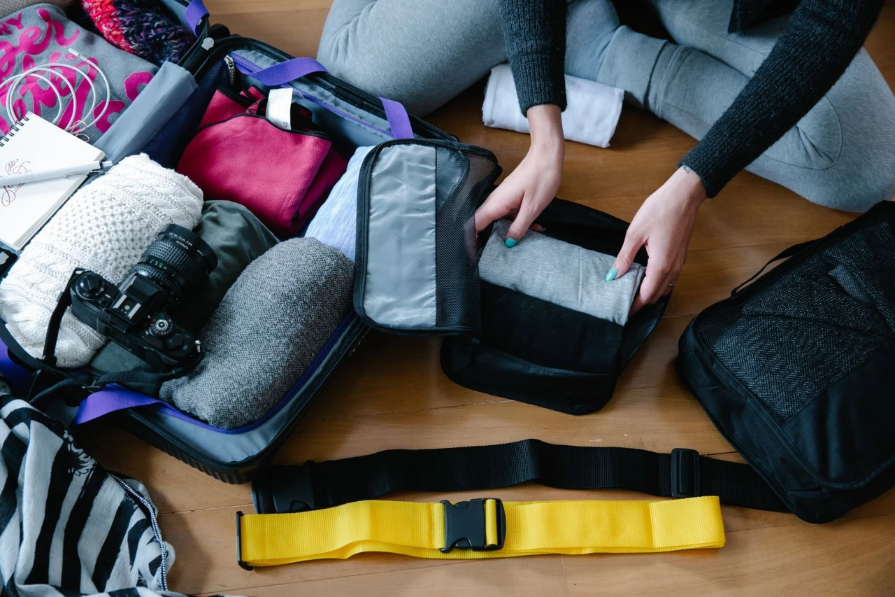 Packing cubes neatly organizing clothes inside an open carry-on suitcase